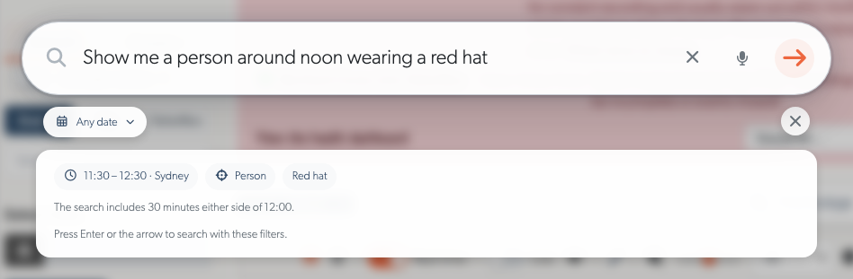 A search for a person wearing a red hat, with the interpreted time window shown before searching